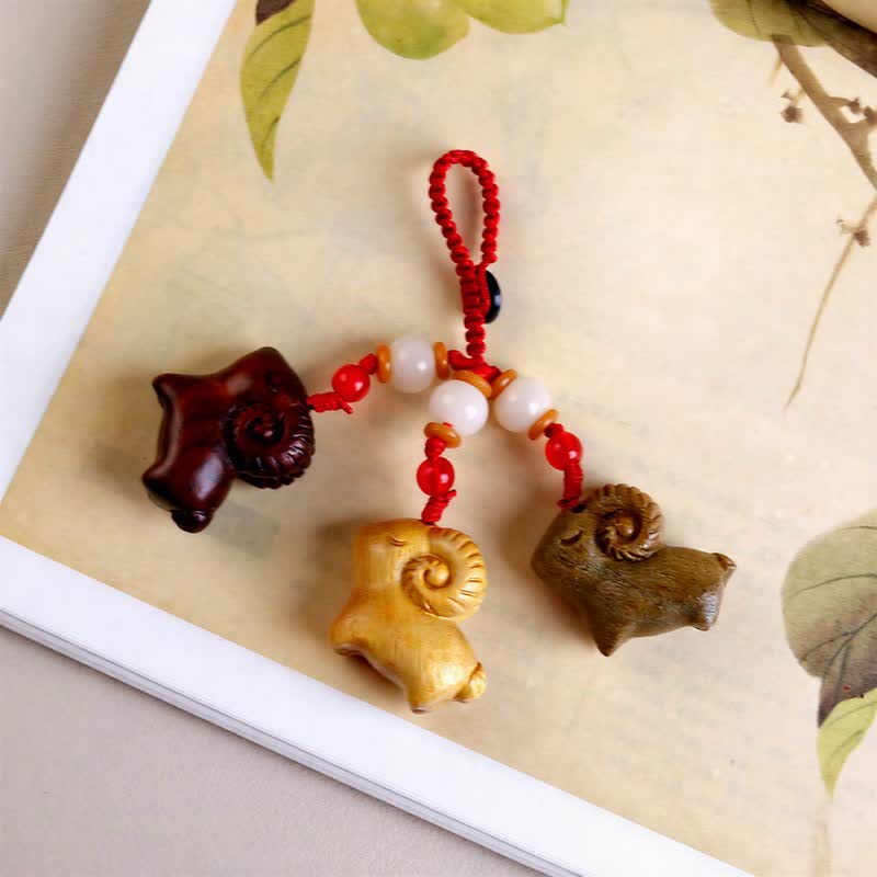 Buddha Stones Hand-Carved Sandalwood Ebony Wood Three Goats Prosperity Keychains - image 1